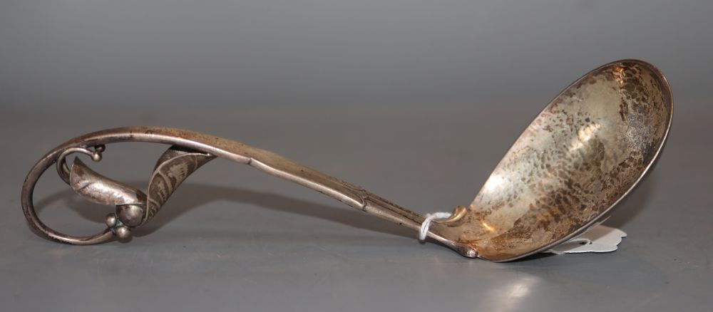 A 1920s Georg Jensen sterling silver leaf and berry ladle, design no. 141, 18.8cm, 80 grams.